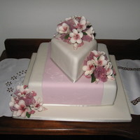 My First Wedding Cake Made for my friend's wedding. Frangipanis were requested, in this pink/aubergine colour. The layer of rolled fondant across the square...