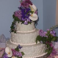 Garden Wedding Cake Fondant with cream cheese icing and edible butterflies. Hand painted cake fondant covered cake board. Fresh flowers also arranged for bride...