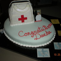 Lvn Graduation Fondant nurses bag on top of fondant covered base. Fondant stethoscope on side of cake. I wasn't too sure about this one, but everyone...