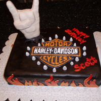 Harley-Davidson Riding, Heavy Metal Rocker Cake. Yellow cake, strawberry filling, chocolate fondant, hand is RCT. Logo is frozen buttercream transfer.