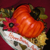 Fall Pumpkin Half spice, half devil's food bundt cakes with cream cheese icing covered in mmf. Stem, tendrils, and banner in gumpaste. Silk flowers...