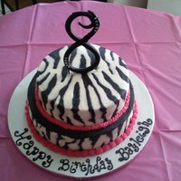 Bayleigh 2 tier white cake with zebra and hot pink. Gum paste blingy "8"
