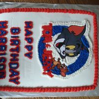 Tom & Jerry This is a gluten-free chocolate cake with strawberry filling. All buttercream icing. Tom & Jerry are colorflow.