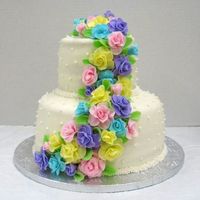 First Wedding Cake! Both layers are vanilla cake with alternating lemon and raspberry filling. The cake is covered in MMF and the roses are also MMF. Turned...