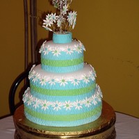 Summer Daisy Three tier cake in fondant and brandy ponque flavor. All the daisy made in pastillage. The cake size are a 6", 8" and 9".