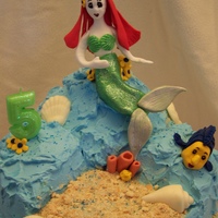 Ariel Mermaid Under The Sea Cake Lemon cake with blackberry pastry cream filling, IMBC frosting. Ariel is gumpaste and fondant. Shells are chocolate. Sand is crushed...