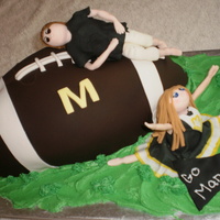 Manets Cheerleading And Football This was a donation cake for the local youth cheerleading and football team. Fondant coverd carved football (first carved football cake)...