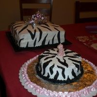 Zebra First Birthday Cakes Large Cake- White buttercream with black fondant stripesSmall Cake- white buttercream with hand drawn black buttercream stripes