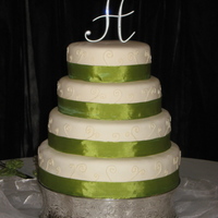 Elegant Wedding Cake My first 4 tiered cake :) Covered in MMF with piped swirls and ribbon on each tier.