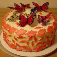 Leaf Butterfly Cake fonadant leaves, unedible butterfilies on a yellow cake with white buttercream.