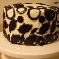 Black And White yellow cake and lemon buttercream. Black circle and leaves on white butter cream.