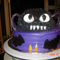 Spider For Noah Yellow cake on bottom with b/c icing , chocolate cake top w/ bc icing marshmellow eyes and teeth and rolled buttercream bats and candy corn...