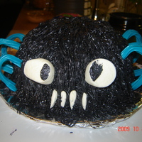 Spider chocolate cake with buttercream icing marshmellow teeth and eyes and twizzler legs