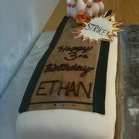 Bowling Fun! This cake is half chocolate and half white cake with chocolate butter cream and white butter cream. The pins are made with gumpaste....