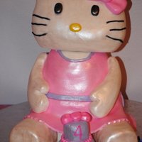 Hello Kitty This is a vanilla/strawberry cake with butter-cream. Everything is cake but the head. The head is made of RKT. Ultra white sparkle dust...