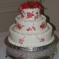 Red & White Wedding Cake 14" 10" 6" round BC with gumpaste flowers & red BC on side of cake to mimic the bride's wedding dress.