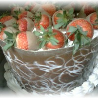 Chocolate Ambrosia Red Velvet and Double Fudge Chocolate with cream cheese icing, milk chocolate collar, bordered and filled with whipped cream, topped with...