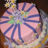 Elephants & Daisies 8" round w/BC icing, BC elephants, Fondant stripes & daises. Made for a little girl that loves elephants, purple & pink. (...