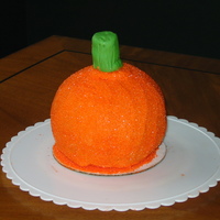 Sparkly Pumpkin Yellow cake, filled with vanilla bean buttercream, covered in orange flavoured buttercream with orange sanding sugar. Green fondant stem. I...