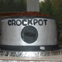 Chili Cook Off 4 layer 8" round chocolate cake filled with chocolate fudge frosting, covered in light grey fondant with silver lustre dust. All...