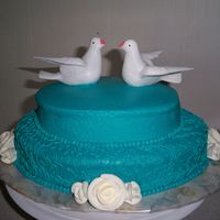 Bradley Oval cakes with bc icing, royal icing roses. Doves topper.