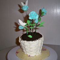 Rose Flower Pot Baked in a terra cotta pot. I torted and filled every 2 inches. Gumpaste flowers and putting them on wire are also first time. Covered with...