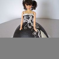 First Doll Cake I tried to copy my youngest daughter's prom dress! It was close. Cake is carmel with apple buttercream.