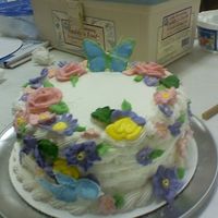 0427092013.jpg My 12 year old sister and I did this cake. I did most of the flowers and she placed them on the cake.