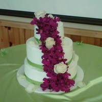 Wedding Cake Wedding cake with green ribbon and purple flowers. Also had matching sheet cakes.