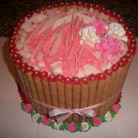 Valentine Baby Shower White Chocolate homemade shavings place on top of a Strawberries and Cream Cake.. Candy roses placed on top
