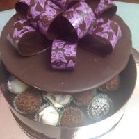Chocolate Box & Bow chocolate box filled with truffles. Lid is cardboard 7" covered with chocolate and decorated with chocolate bow, purple butterfly...