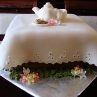 Tea Party Cake for my daughter's 5th birthday. Chocolate cake with whipped ganache filling. All decorations made with fondant. Teapot and plate...