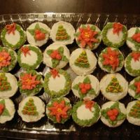 Christmas Themed Mini Cupcakes Mini cupcakes frosted with vanilla butter cream and decorated in various Christmas themes.