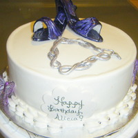 Purple Pumps Vanilla cake with gum paste pumps, charm bracelet and butterflies.