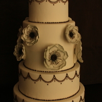Anenome Cake Four tier white cake with green and brown anemones and brown royal icing piping detail.