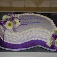 Birthday Girl At The Bank Paisley shape white cake, buttercream icing, fresh flowers and ribbon.