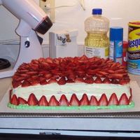 Strawberry Cake This cake was so much fun to make. Simple white cake on the inside, a layer of strawberry preserves to separate the layers. Covered in a...