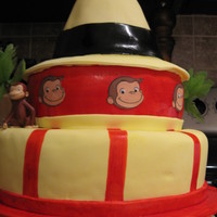 Curious George The bottom layer is red velvet. The middle is banana cake and the hat is strawberry cake.