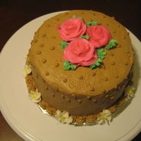 Wilton Class This is a yellow cake with chocolate buttercream icing and pink roses.