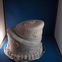 Topsy Turvy Cake 2009 Pastel pink and lavender fondant.(marbled pink on top, marbled fondant on bottom) Large fondant pearls around bottom cake cutouts of circle...