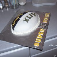 New Orelans Saints Cake For Superbowl Xliv Vanilla almond cake with vanilla buttercream, black and white fondant, x-acto knife cut fondant 'saints' logo painted with yellow...