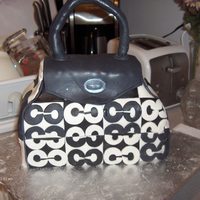 Coach Bag Cake This was my first attempt at a purse cake. Fondant covered with gumpaste patches and appliques. This cake stands about 8 inches tall, 5...