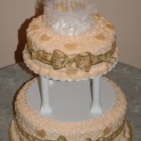 50Th Anniversary Ivory icing, with gold ribbon and bows, and fondant hearts.