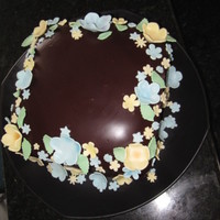Godson's Baptism Chocolate cake, chocolate almond filling, and ganache covering. Flowers are a gumpaste fondant mix.