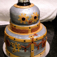 Scrapyard Robot My husband actually designed and did most of the decorating of this cake. Covered in fondant, painted with luster dust.Chocolate with...