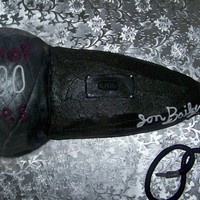 Microphone This is a Triple Chocolate Cake with fondant accents and round mic top.it says MAN OF 1000 VOICES It was made for a Groom who is a voice...