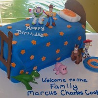 Andy's Room two layer 10" square cake cut in half and stacked to form bed covered in fondentHead and foot board on bed made out of chocolate (...