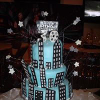 New York, New York This cake was for a 30th Birthday New york themed party. Fondant covered with chocolate buildings.