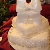 White Ribbon THREE TIERS CAKE, GUM PASTE BOW, LIGHTS IN THE BOW, IVORY FONDANT, CARROT CAKES, AND STAWBERRY SHORT CAKE.