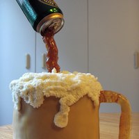 Beer Mug carrot cake covered with MMF with sugar handle and foam is buttercream